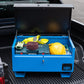 Blue metal tool box open with a range of electrical tools inside and a yellow hard hat. The toolbox is on the back of a pick up van.