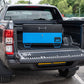 Blue metal tool box closed with a black lid on the back of a 4x4 pick up truck.